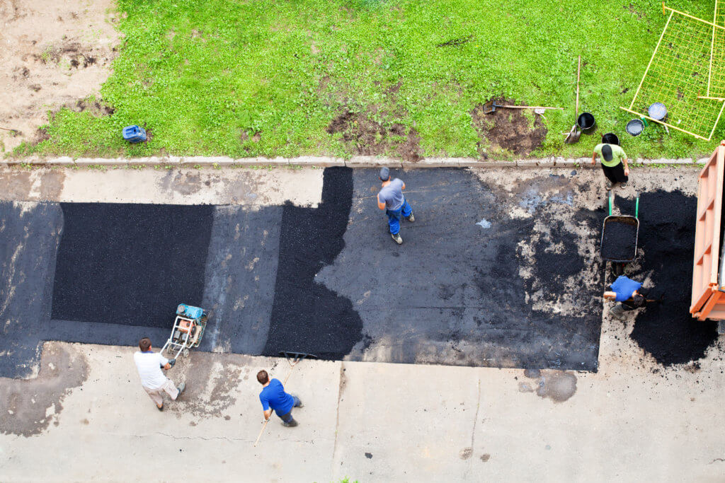 Patching driveway potholes in West Palm Beach