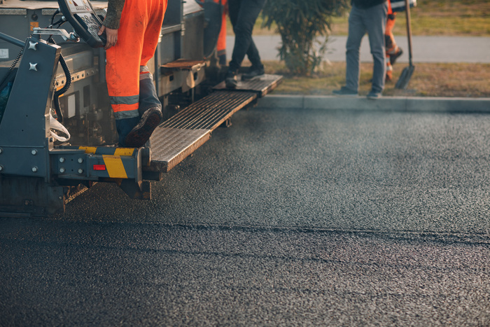 Asphalt paving. Paver machine and road roller.
